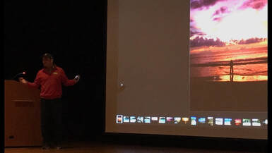 Owner, Todd Blechner, presenting a slideshow from travels in SE Asia.